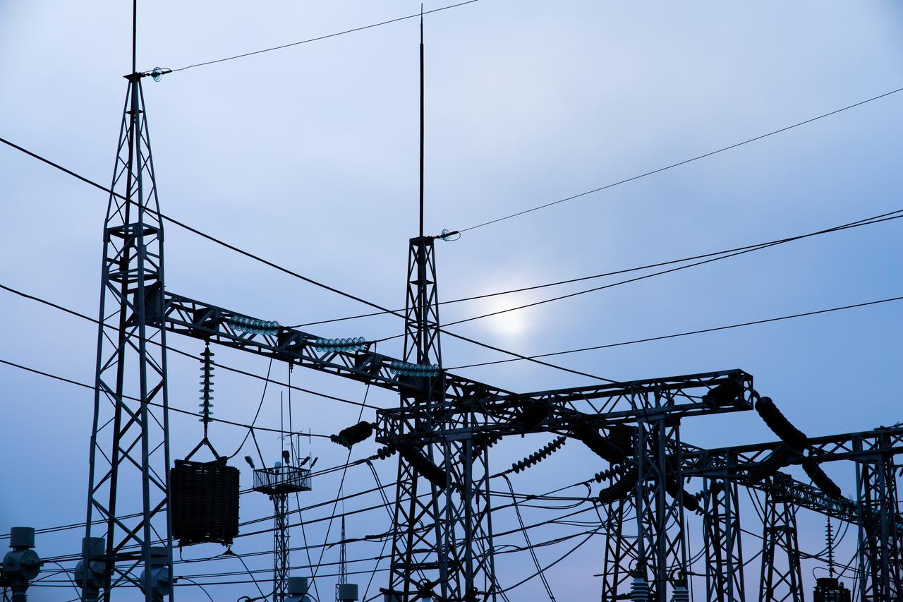 High-voltage substation against a blue evening sky